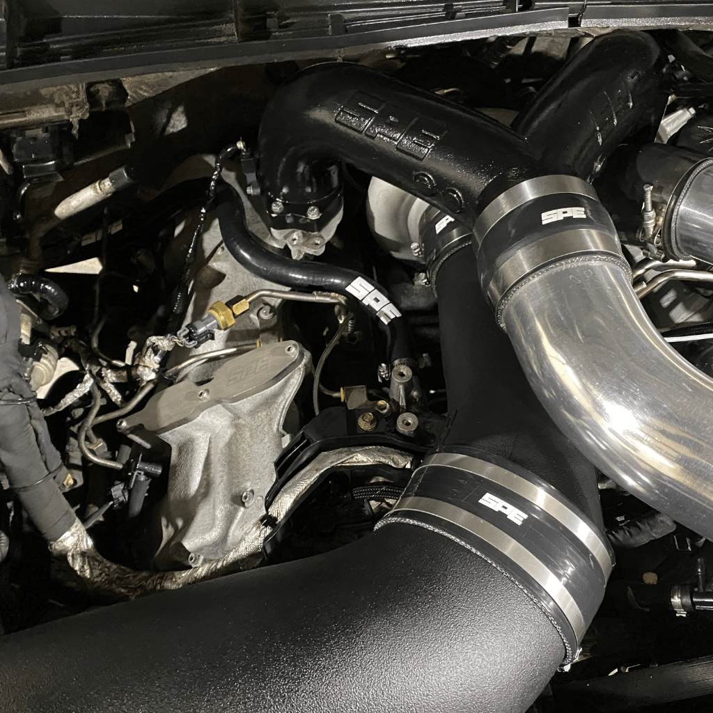 Close up under hood of SPE 6.7 Powerstroke Coolant Hose Reroute Kit